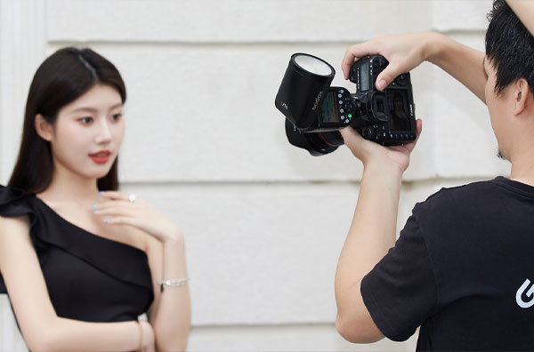 فلاش اسپیدلایت گودکس Godox و مرد در حال عکاسی از خانم مدل